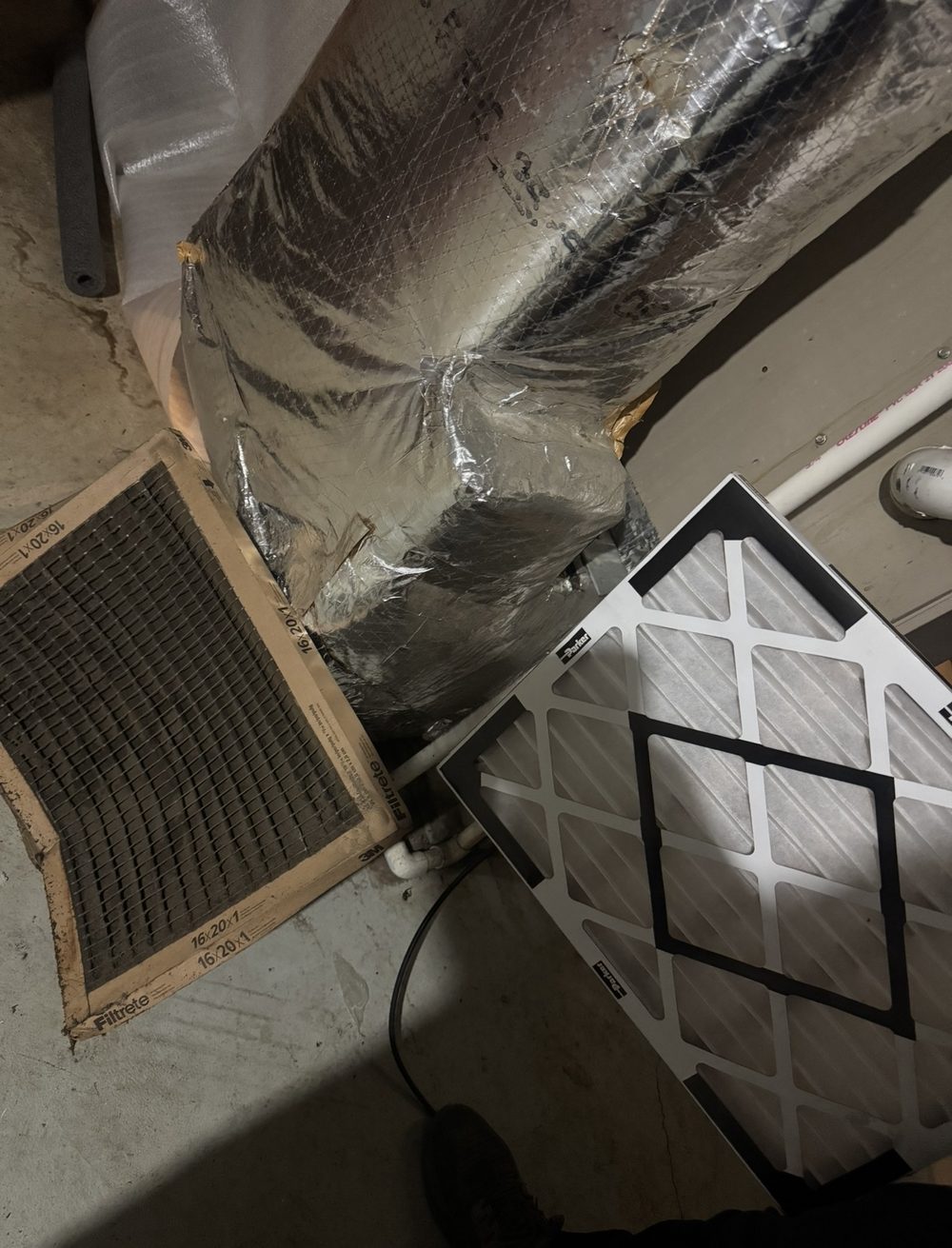 Before and after air filter comparison โ a black clogged 16x20 filter next to a clean new pleated filter