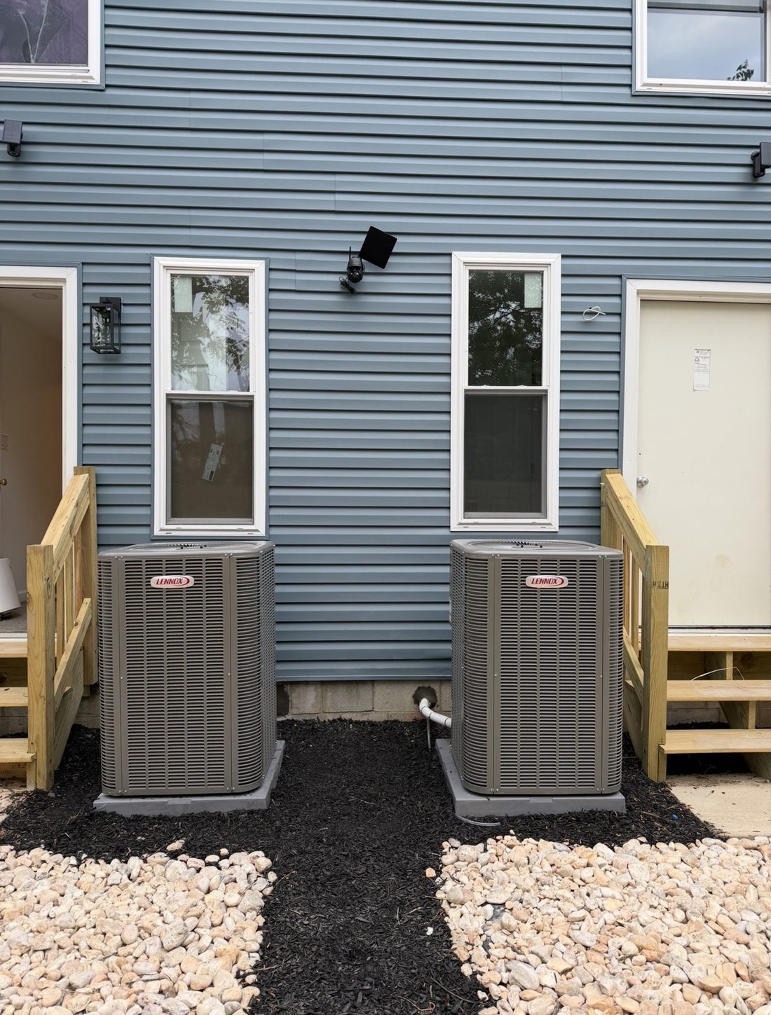 Two Lennox AC condenser units installed at a new construction home
