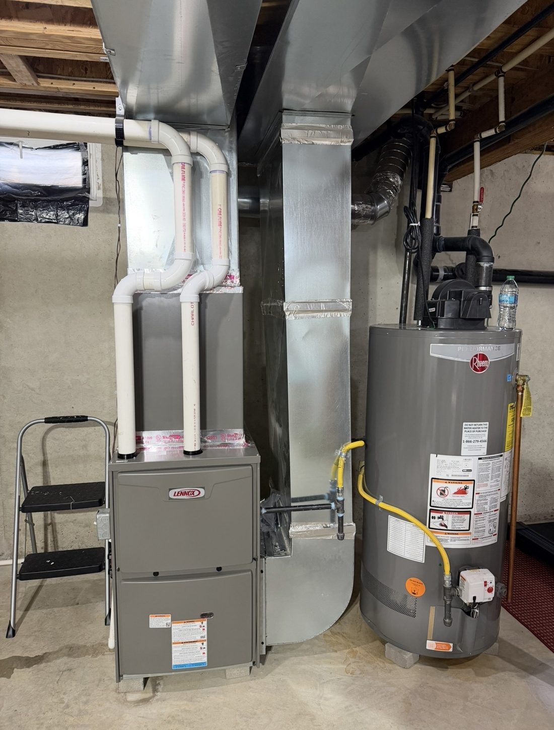 Lennox high-efficiency gas furnace and Rheem water heater installed in a basement